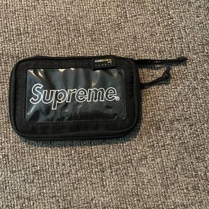 Black Supreme zip wallet.